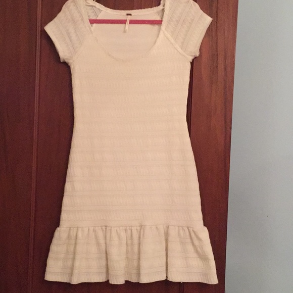 white dress with ruffles at the bottom